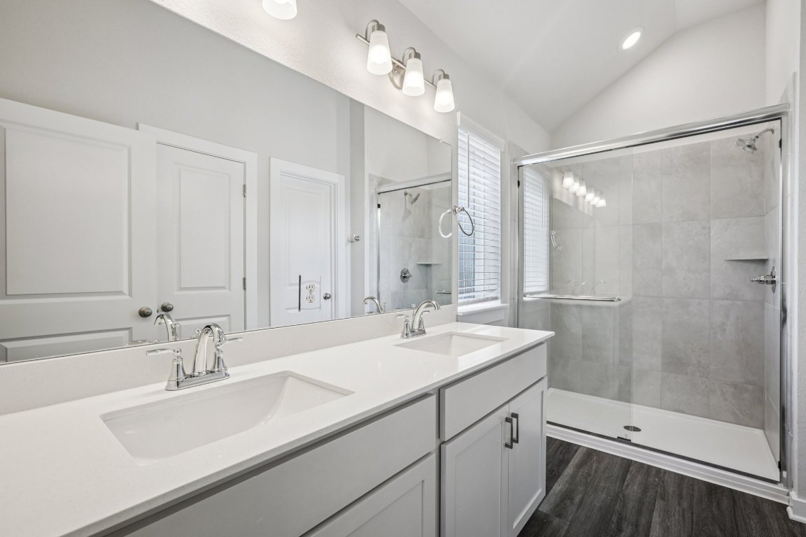 2304 Delano Drive Leander, TX 78641 - Photo 21 of 31 a bathroom with a sink double vanity shower and a mirror