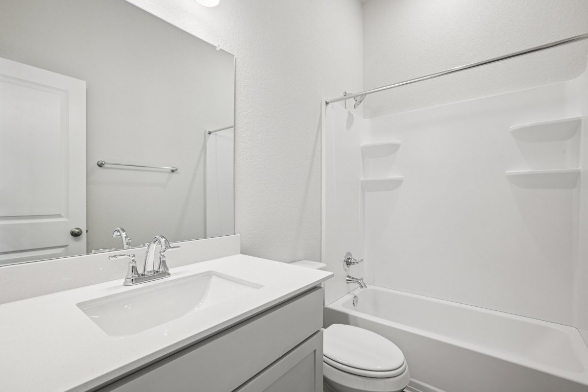 2304 Delano Drive Leander, TX 78641 - Photo 27 of 31 a bathroom with a sink toilet and shower