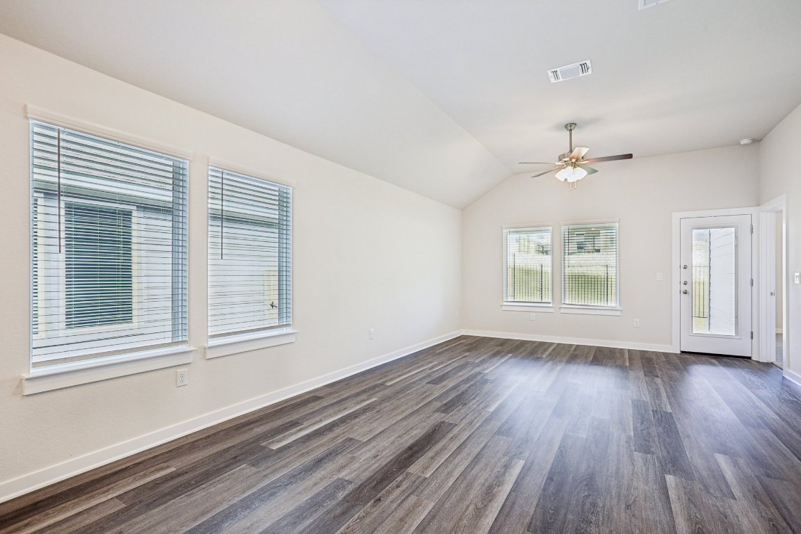 2304 Delano Drive Leander, TX 78641 - Photo 5 of 31 a view of an empty room with wooden floor and a window