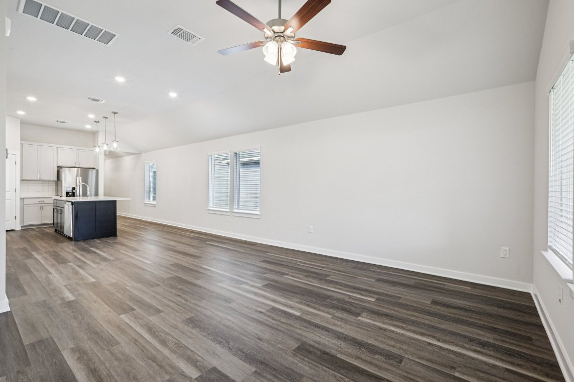 2304 Delano Drive Leander, TX 78641 - Photo 8 of 31 a view of kitchen and empty room with wooden floor