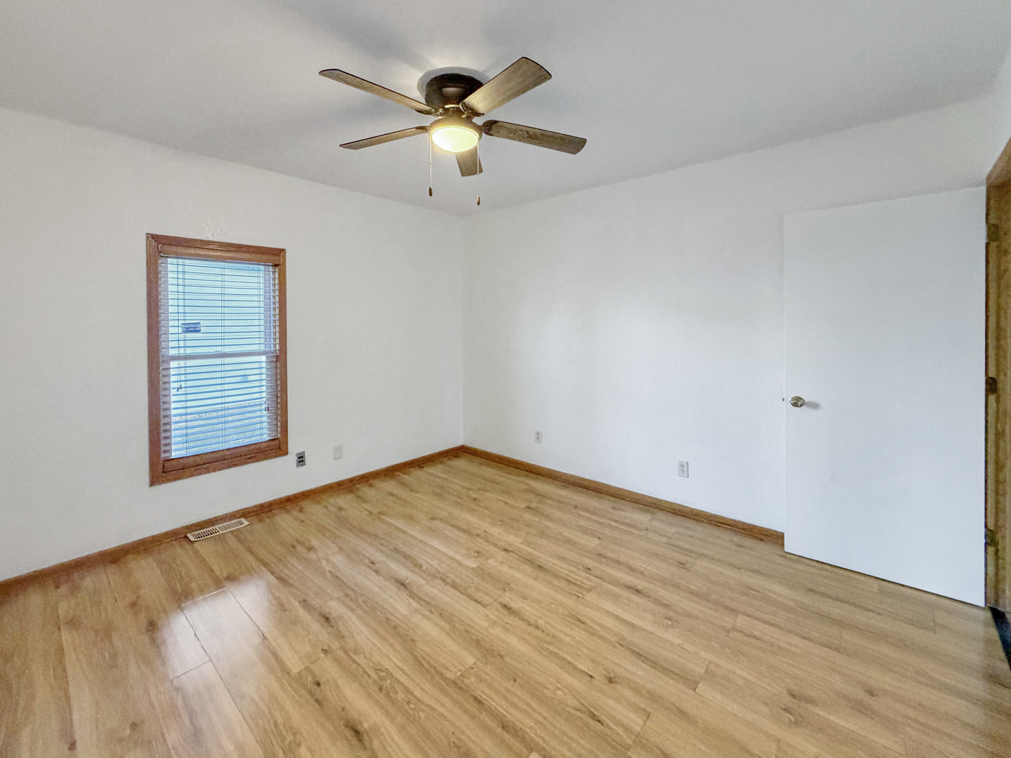 827 East Garden Street Freeport, IL 61032 - Photo 13 of 23 an empty room with wooden floor chandelier fan and windows