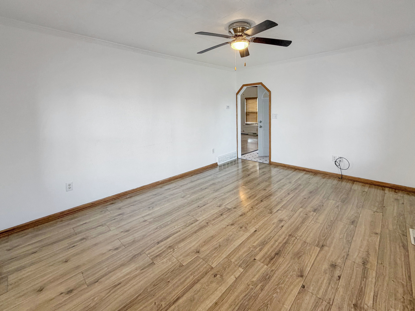 827 East Garden Street Freeport, IL 61032 - Photo 14 of 23 an empty room with wooden floor ceiling fan and window