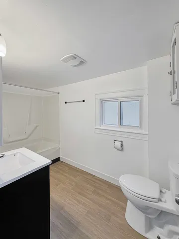 a bathroom with a sink a toilet and mirror