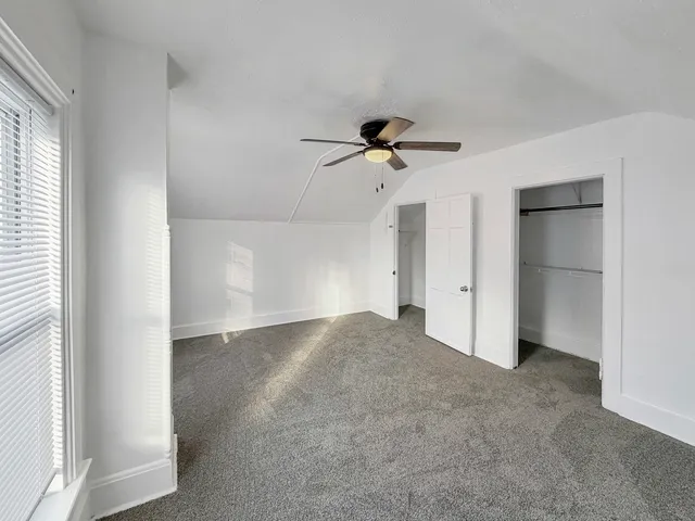 a view of empty room with ceiling fan