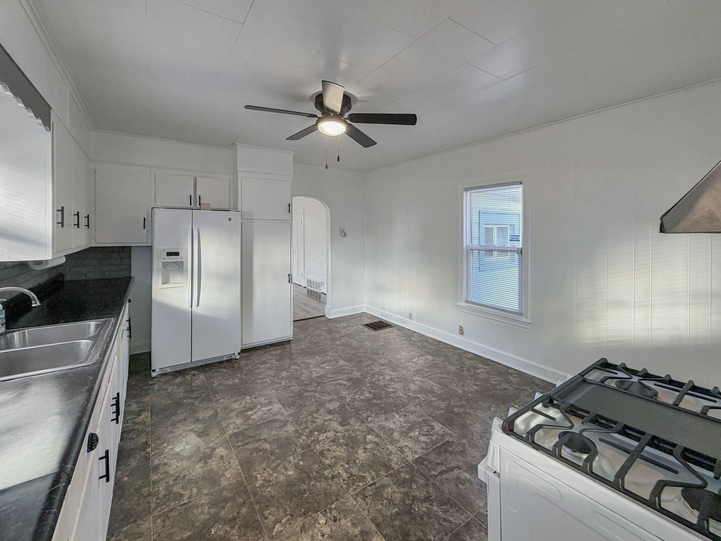 827 East Garden Street Freeport, IL 61032 - Photo 6 of 23 a kitchen with a stove a refrigerator and a sink