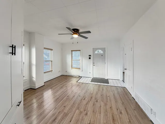 wooden floor in an empty room with a window