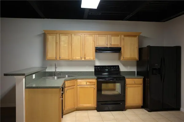 a bedroom with a bed a mirror and lamp