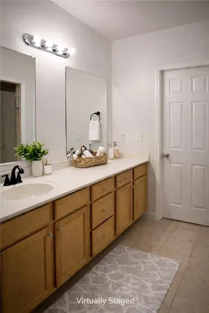 a bathroom with a double vanity sink and mirror