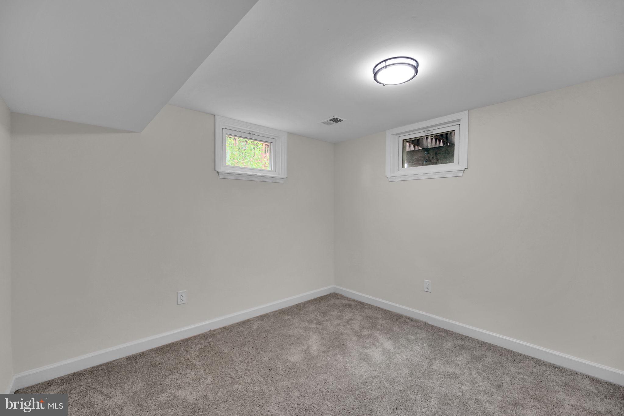8613 Weems Road Manassas, VA 20110 - Photo 24 of 50 an empty room with a white wall and a window