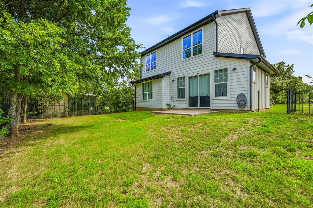 745 North Miller Avenue Stephenville, TX 76401 - Photo 28 of 31 Expansive grassed backyard with mature trees and partial fencing