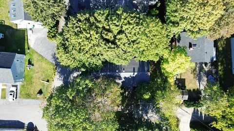 an aerial view of a house with a yard and garden