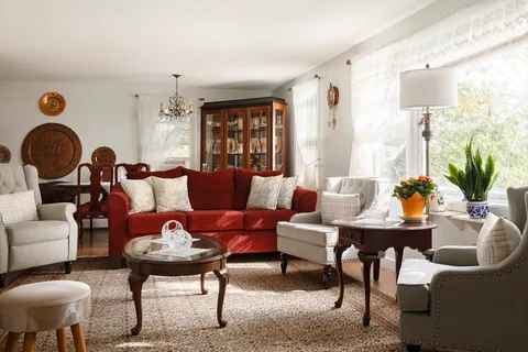 a living room with furniture and a potted plant