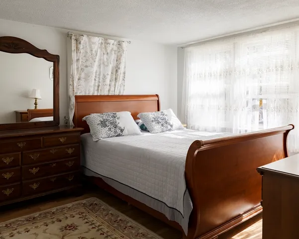 a bedroom with a bed and window