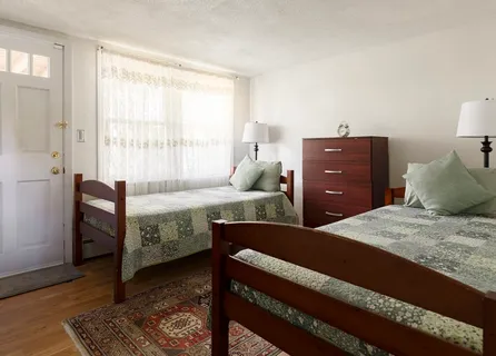 a bed room with a bed and a window