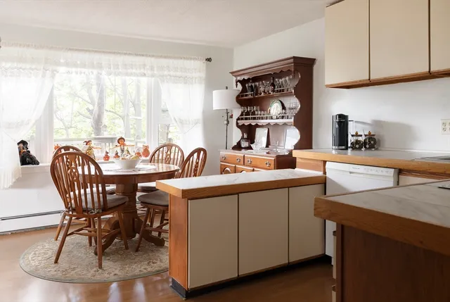 a kitchen with a sink a stove and chairs