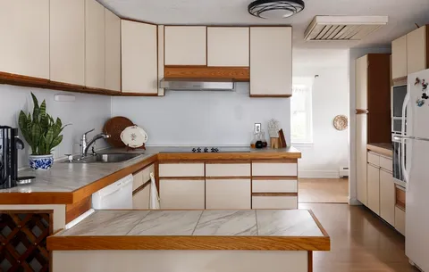 a kitchen with stainless steel appliances cabinets a sink and a refrigerator