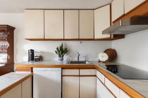 a kitchen with stainless steel appliances granite countertop a sink a stove and cabinets