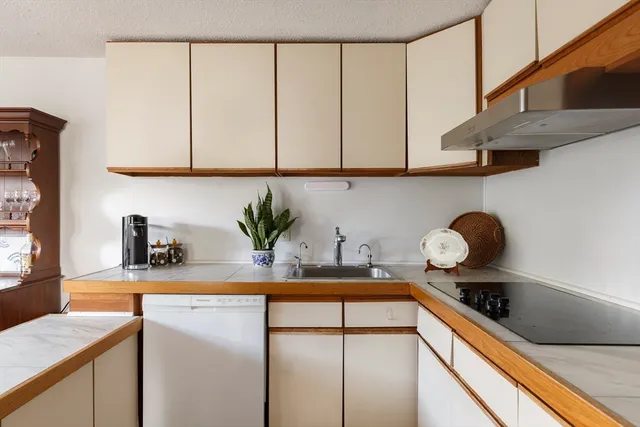a kitchen with stainless steel appliances granite countertop a sink a stove and cabinets