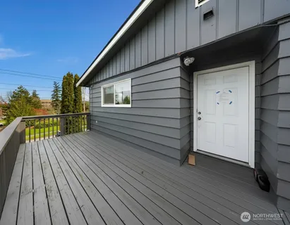 a backyard of a house with table and chairs