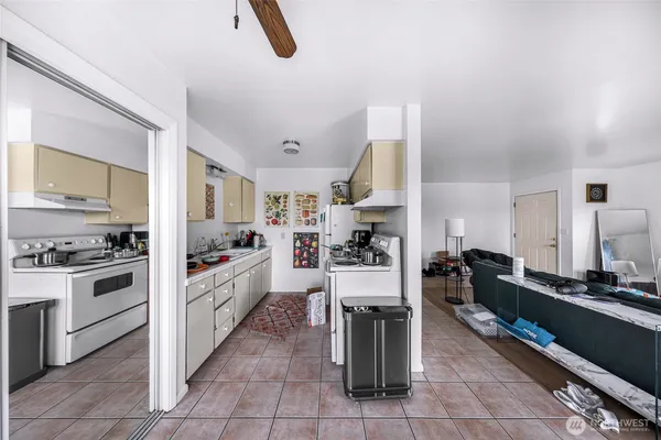 a kitchen with a sink a stove and cabinets