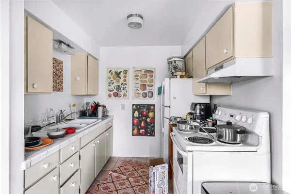 a kitchen with a refrigerator and cabinets