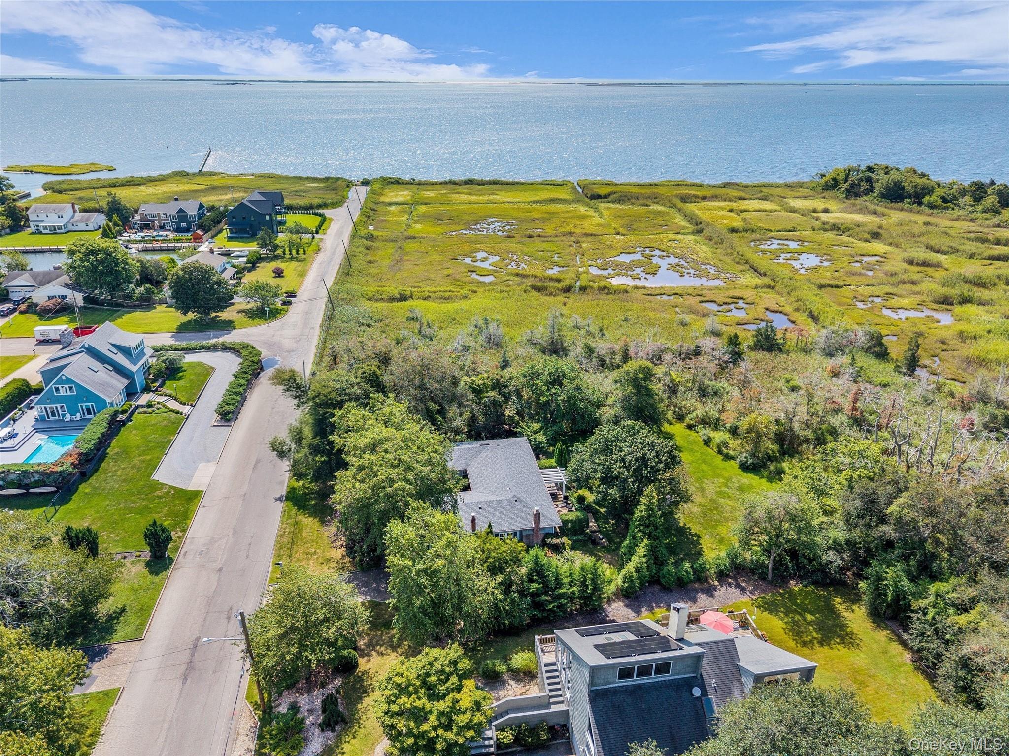 112 Bellhaven Road Bellport, NY 11713 - Photo 1 of 1 Aerial view of residential area with Bellport Bay