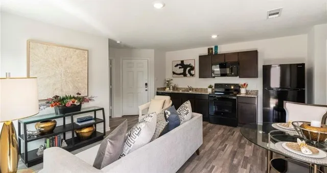 a kitchen with a refrigerator and a stove top oven