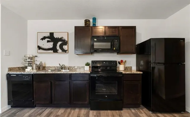 a kitchen with a sink and refrigerator