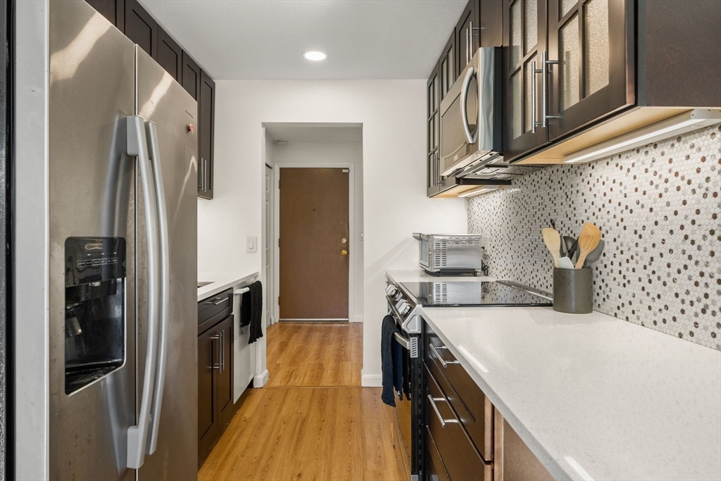 1206 Greendale Avenue, Unit 217 Needham, MA 02492 - Photo 11 of 33 a kitchen with stainless steel appliances a refrigerator and a stove