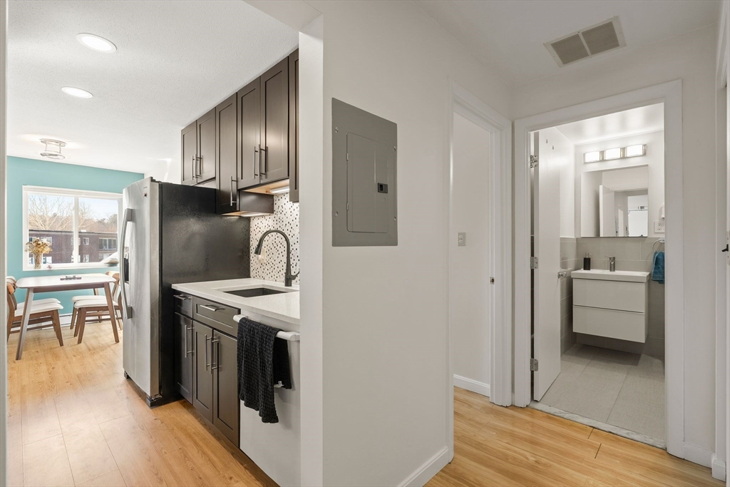1206 Greendale Avenue, Unit 217 Needham, MA 02492 - Photo 15 of 33 a kitchen with stainless steel appliances granite countertop a refrigerator a stove and a wooden floors
