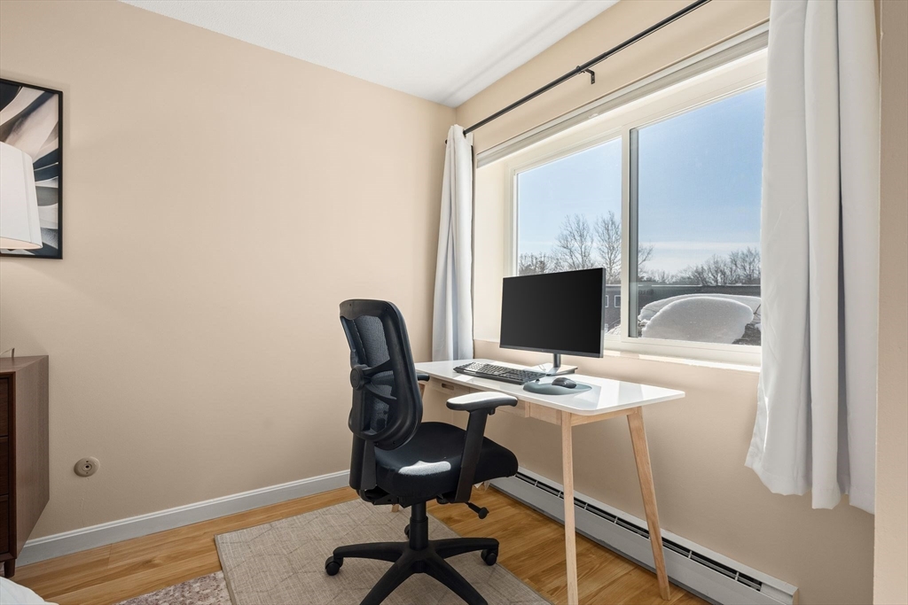 1206 Greendale Avenue, Unit 217 Needham, MA 02492 - Photo 20 of 33 a view of a workspace with furniture and a window