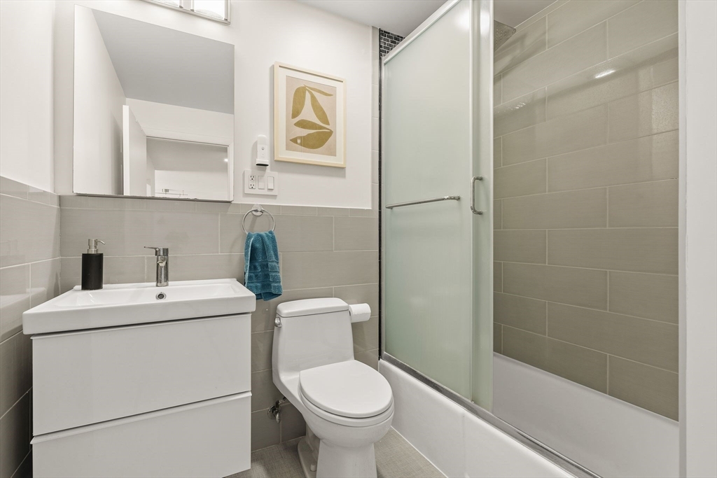 1206 Greendale Avenue, Unit 217 Needham, MA 02492 - Photo 22 of 33 a bathroom with a toilet sink and mirror