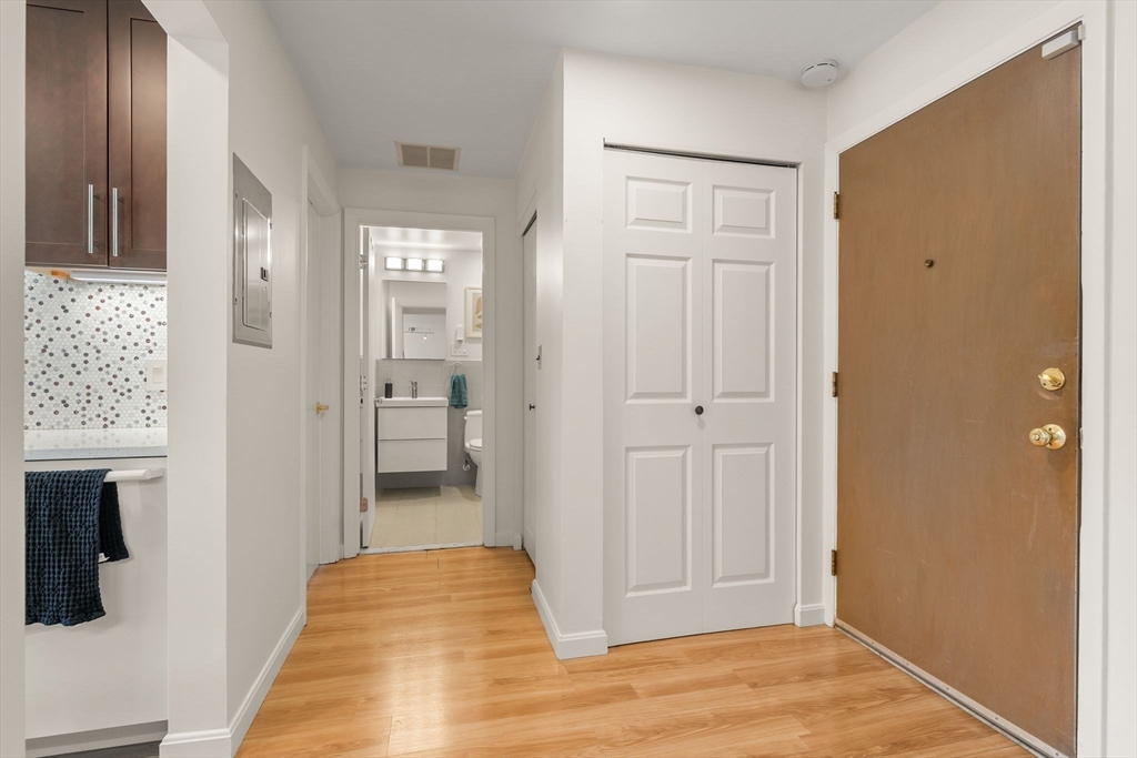 1206 Greendale Avenue, Unit 217 Needham, MA 02492 - Photo 24 of 33 a view of a hallway with wooden floor and a bathroom