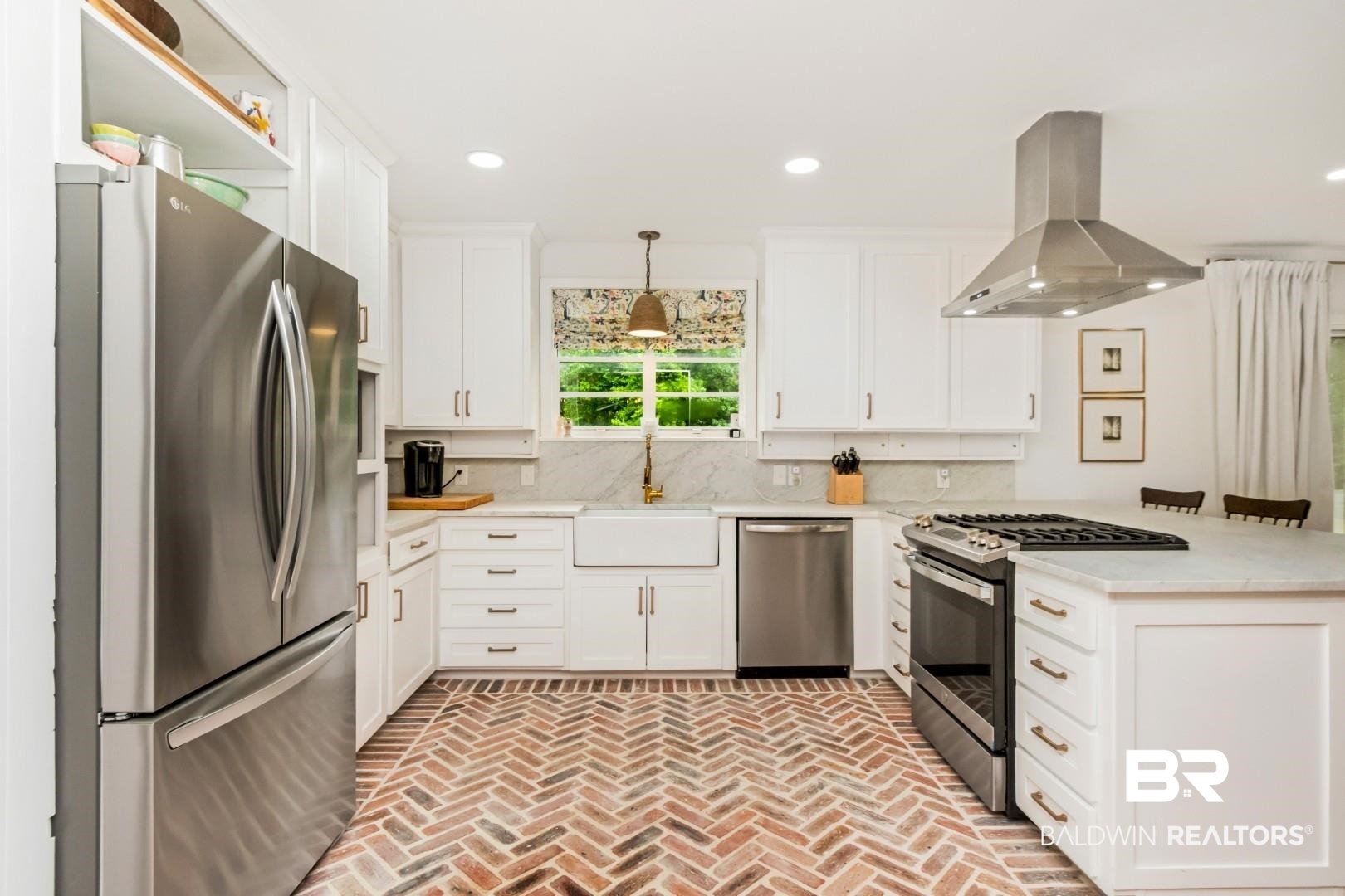 4596 Hawthorne Place Mobile, AL 36608 - Photo 12 of 34 Kitchen featuring brick-patterned flooring, white cabinetry, a farmhouse sink, stainless steel appliances, and a range hood