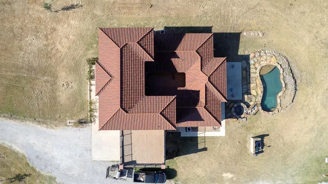 a view of a dry yard with wooden fence