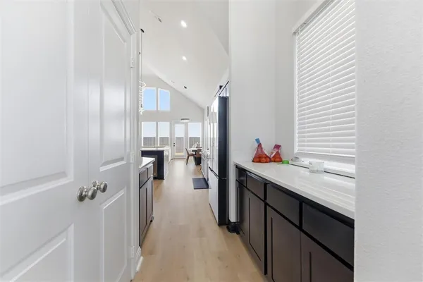 a kitchen with counter top space and wooden floor