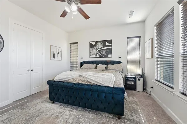 a bedroom with a large bed and a chandelier