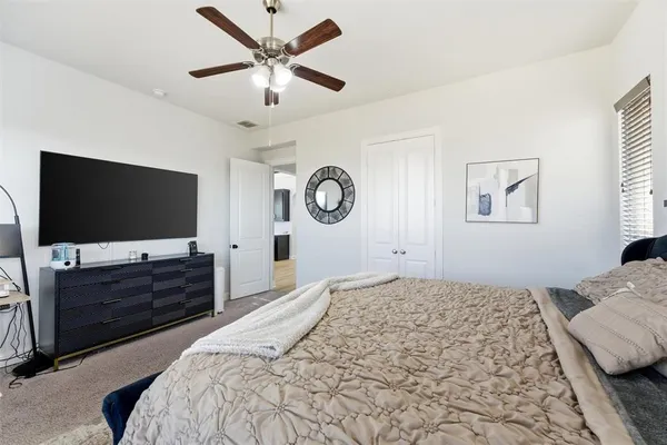 a bedroom with a bed and a flat screen tv