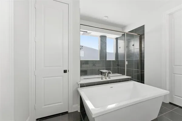 a bathroom with a sink a mirror and a bathtub