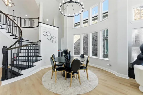 a dining room with furniture a chandelier and wooden floor