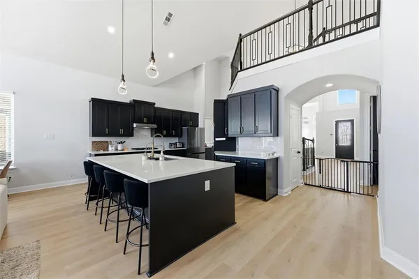 a kitchen with stainless steel appliances kitchen island a sink and cabinets