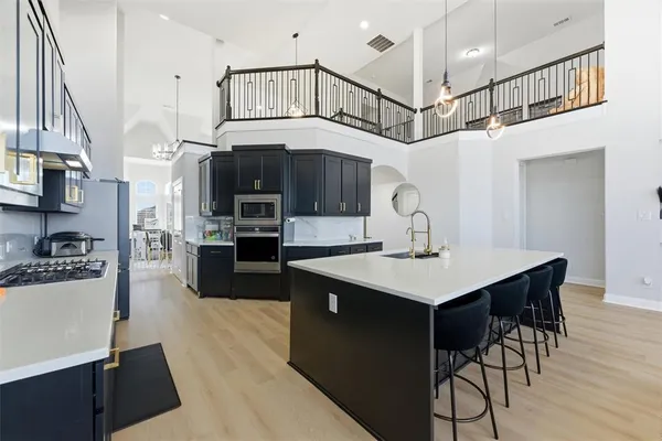 a kitchen with stainless steel appliances a sink and a refrigerator