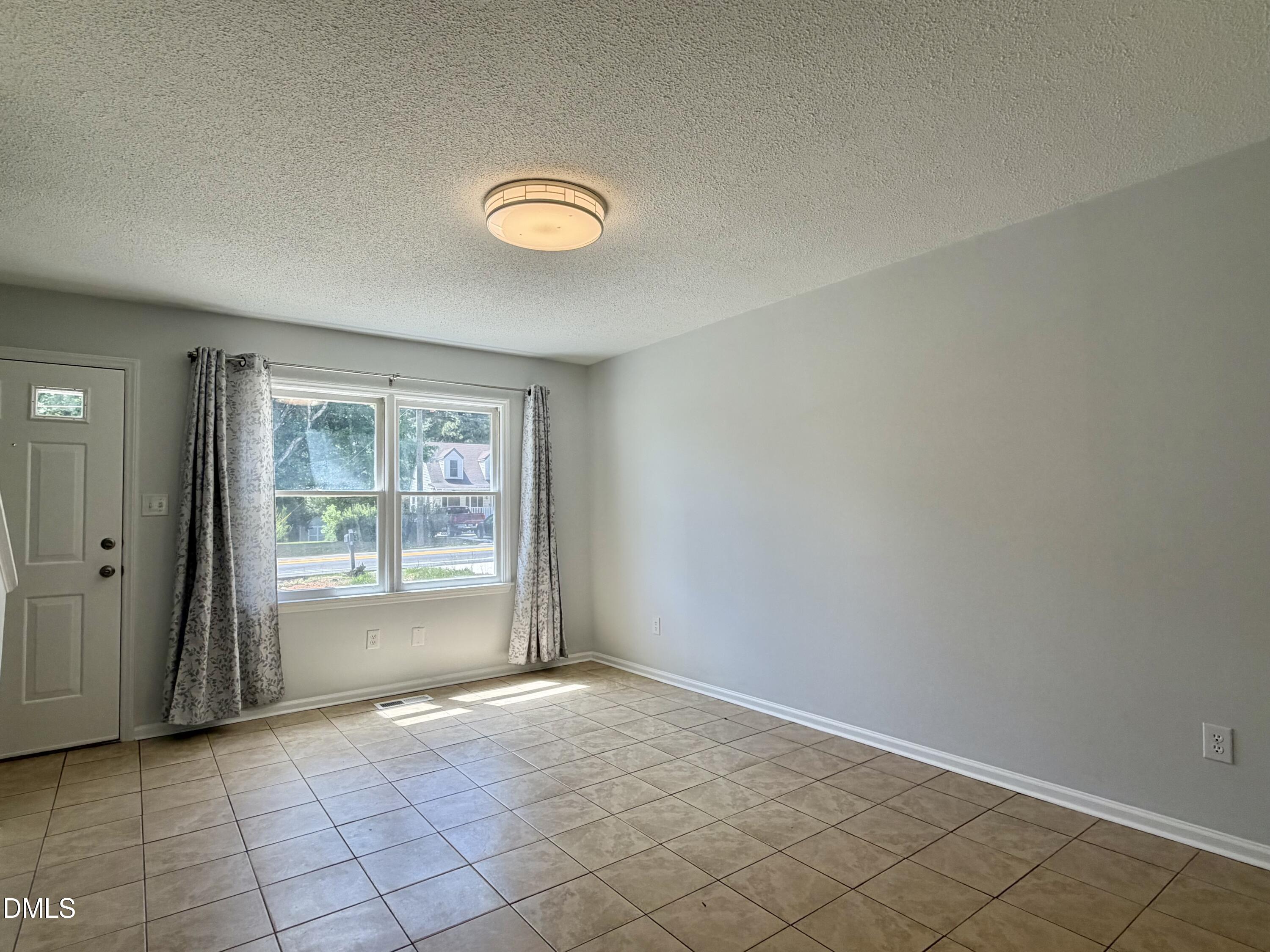 333 Jones Franklin Road, Unit B Raleigh, NC 27606 - Photo 4 of 9 an empty room with windows