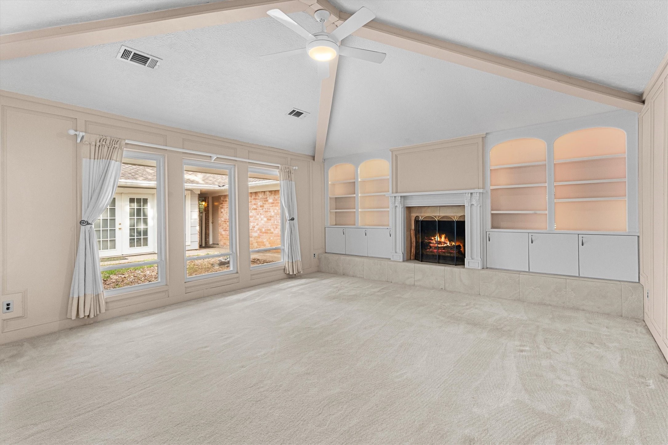 25319 Old Carriage Lane Spring, TX 77373 - Photo 11 of 35 a view of an empty room with a fireplace and a window