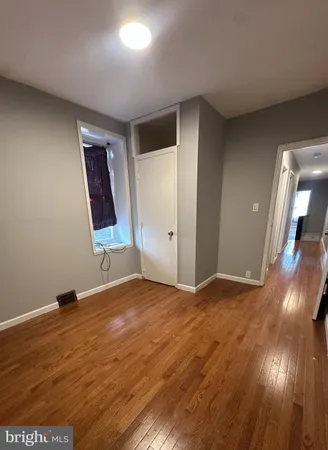 a view of an empty room and wooden floor