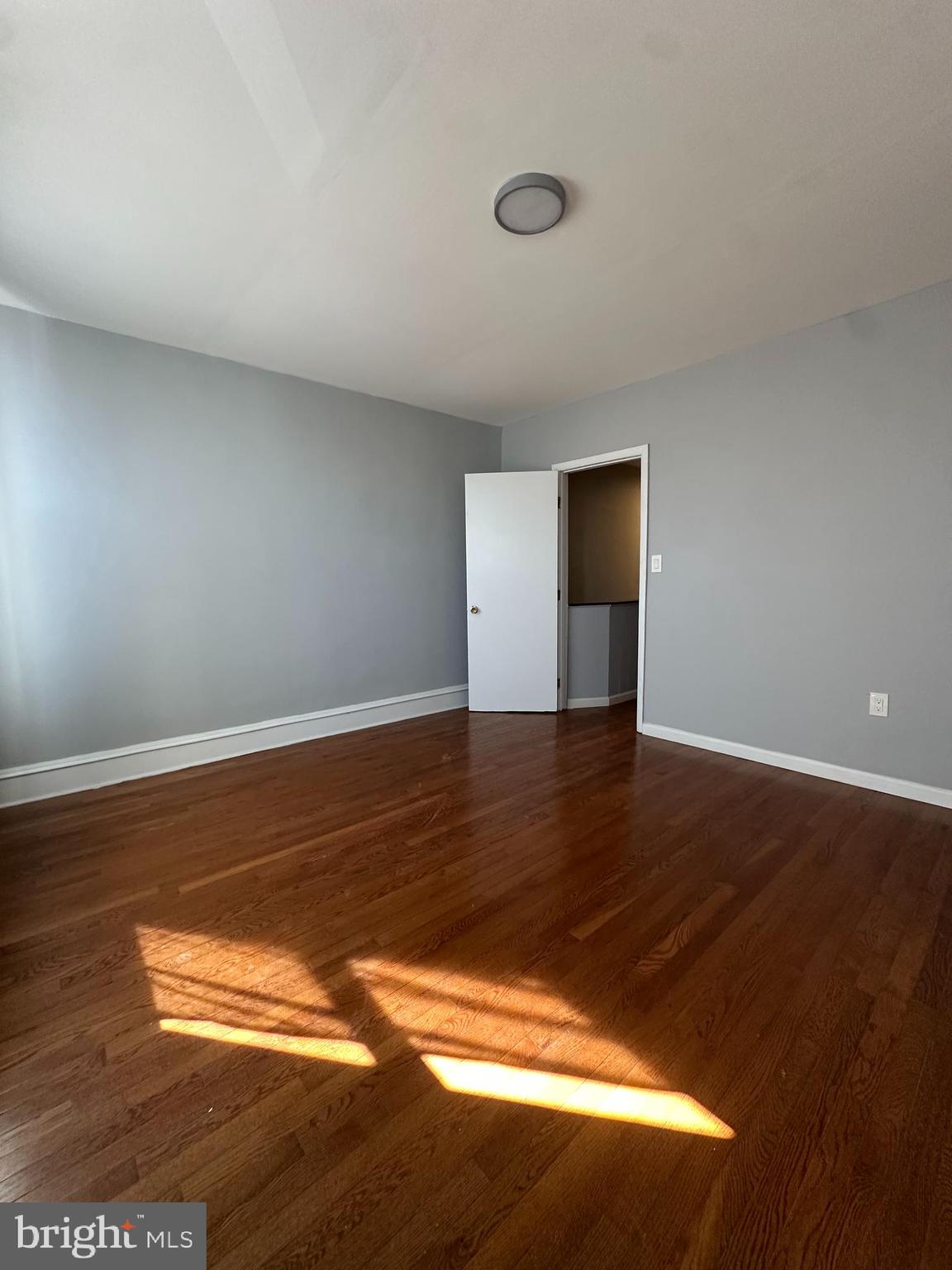 2812 Emerald Street Philadelphia, PA 19134 - Photo 15 of 25 a view of empty room with wooden floor and fan