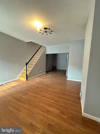 a view of a room with wooden floor