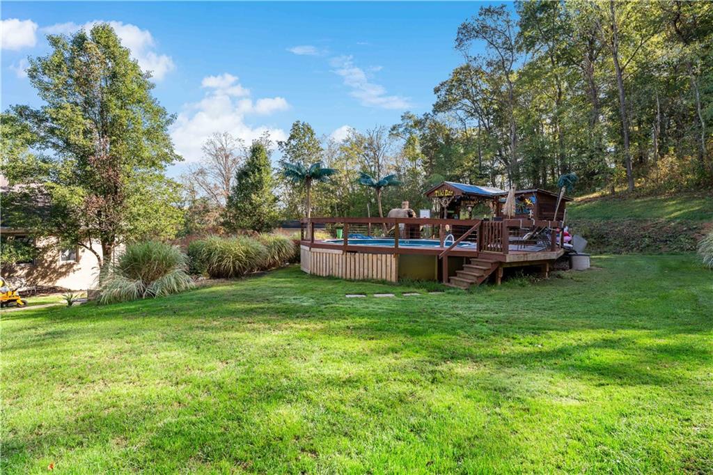 331 North Branch Road Oakdale, PA 15071 - Photo 35 of 41 a view of a backyard with lawn chairs and a large tree