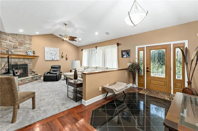 a living room with furniture a flat screen tv and a dining table
