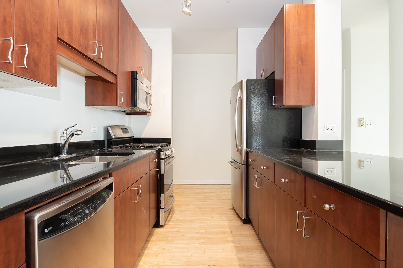 1255 South State Street, Unit 1902 Chicago, IL 60605 - Photo 13 of 33 a kitchen with stainless steel appliances granite countertop a sink stove and refrigerator